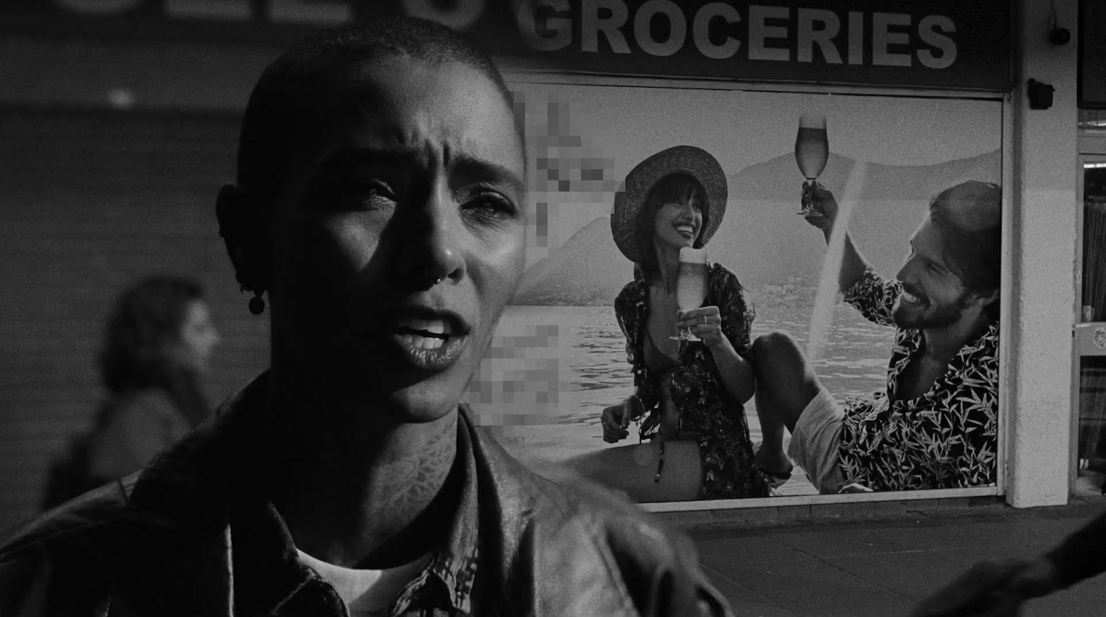 a black and white photo of a man in front of a grocery store