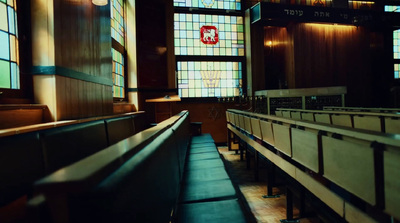 a church with stained glass windows and pews