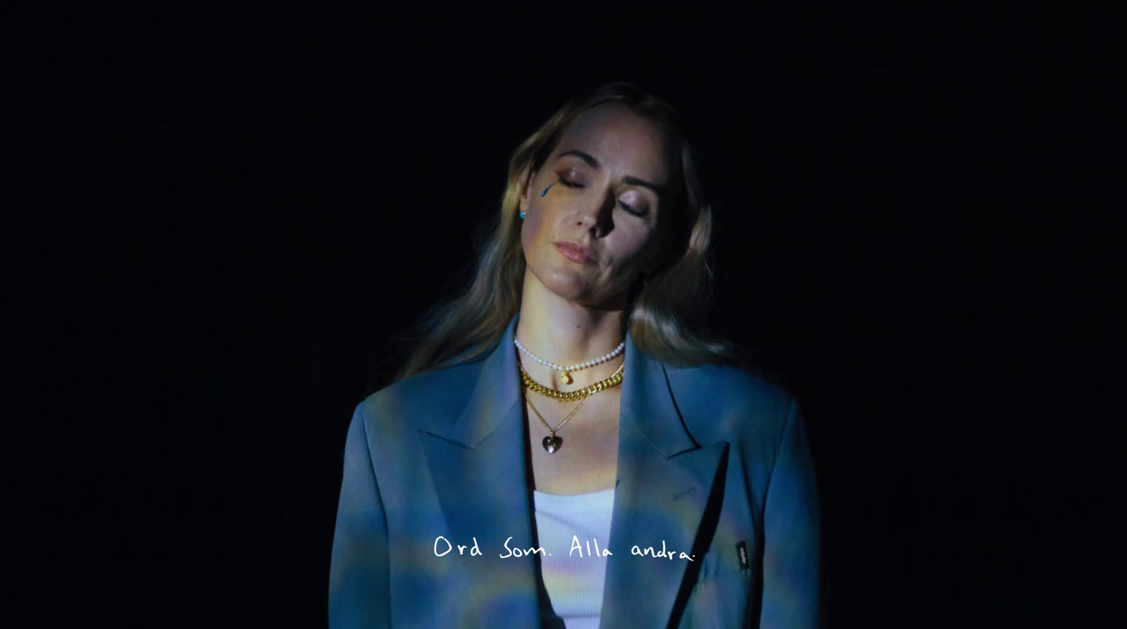 a woman wearing a blue blazer and white shirt