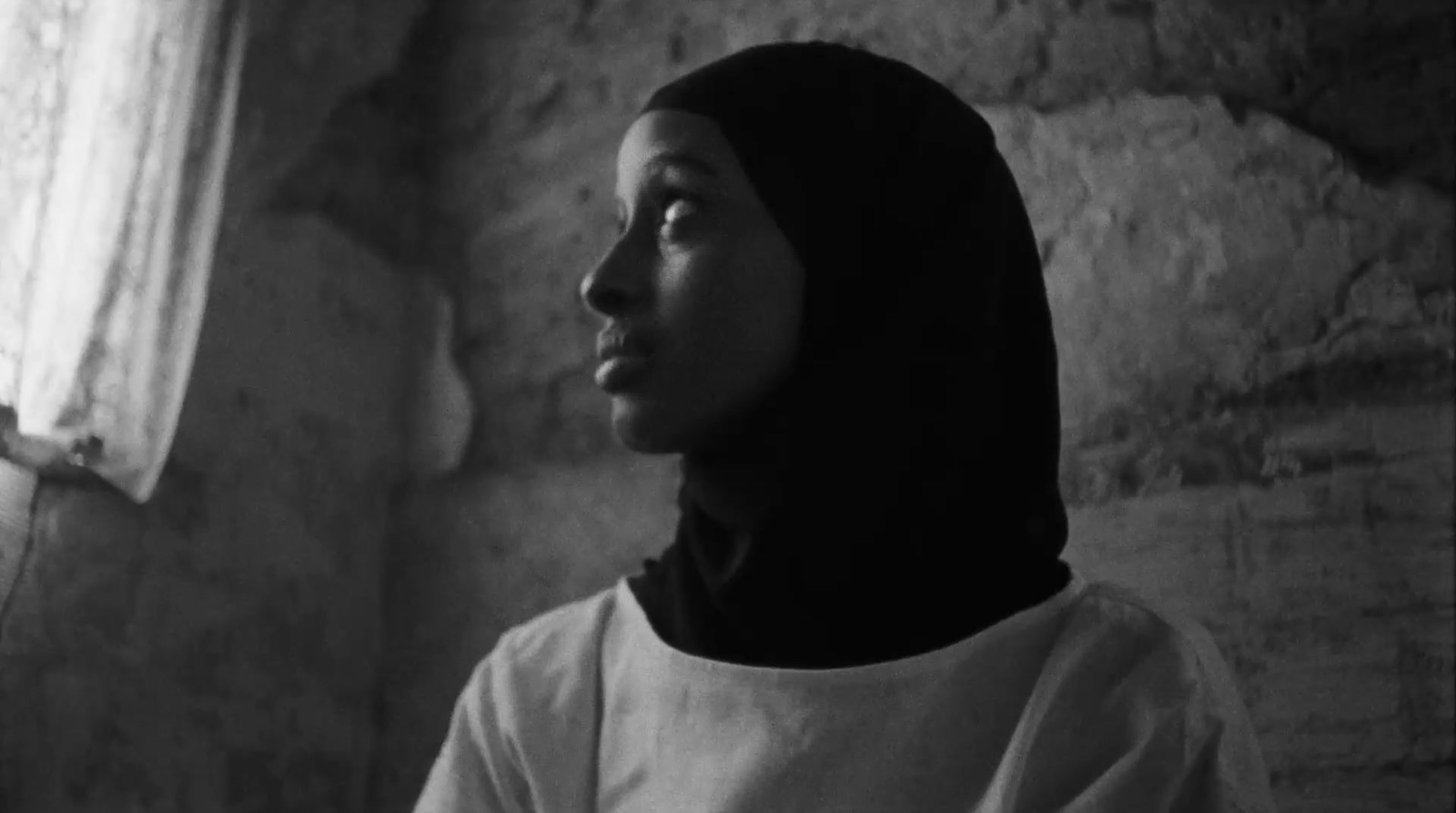 a woman standing in front of a window