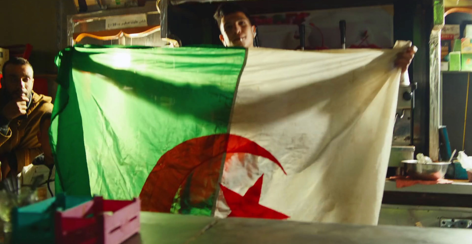 a group of people holding a flag in a room