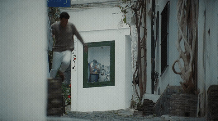 a man walking up the stairs of a building