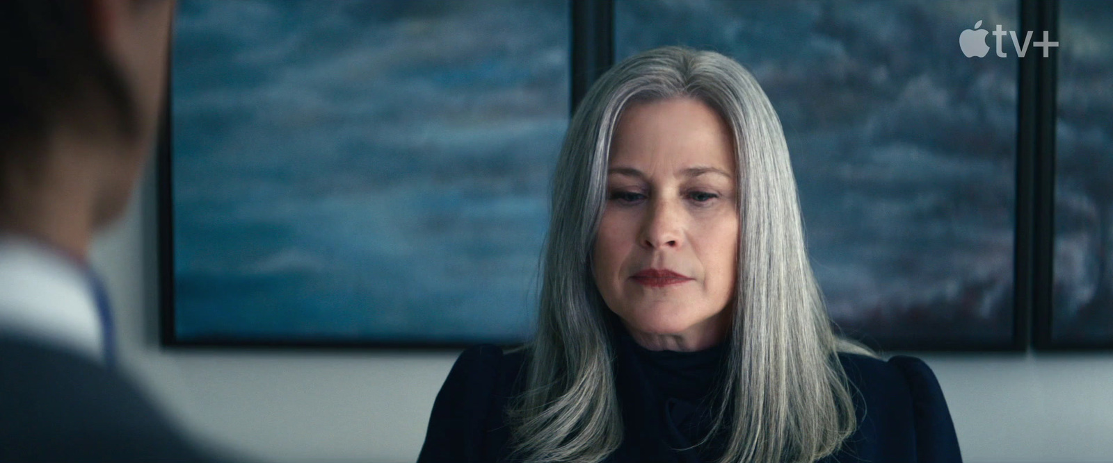 a woman with grey hair looking at a man