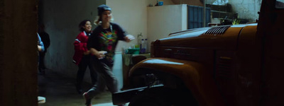 a man and a woman standing in a garage