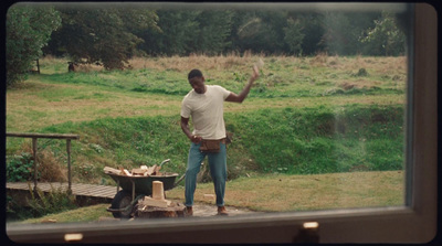 a man standing in front of a fire pit