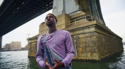 a man standing in front of a bridge