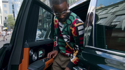 a man standing next to a car with the door open