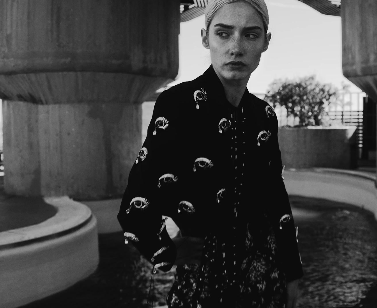 a woman standing in front of a fountain