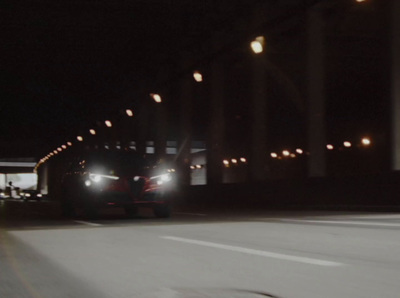 a car driving down a street at night