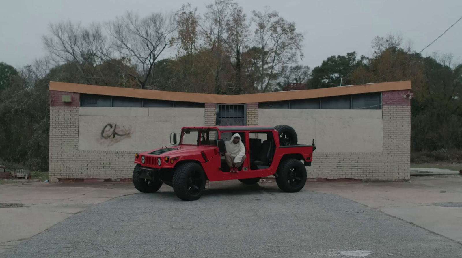 a red jeep parked in front of a building