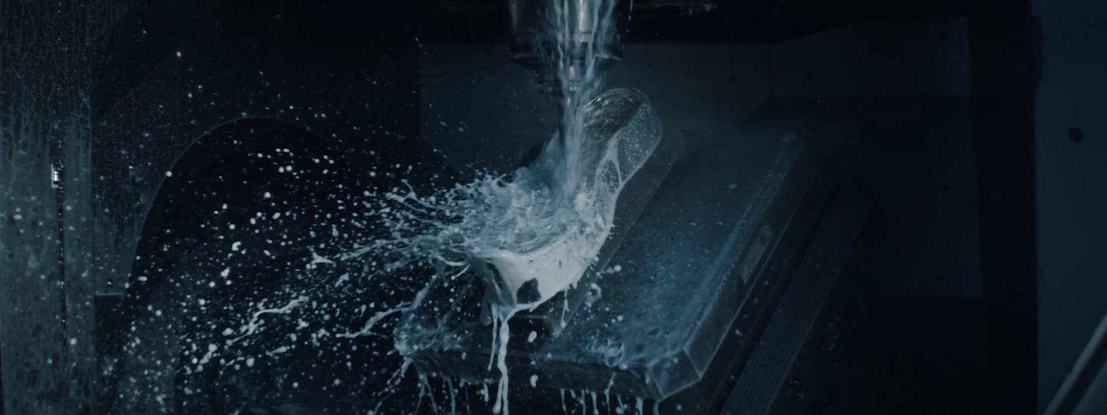 a water spewing from a faucet in a dark room