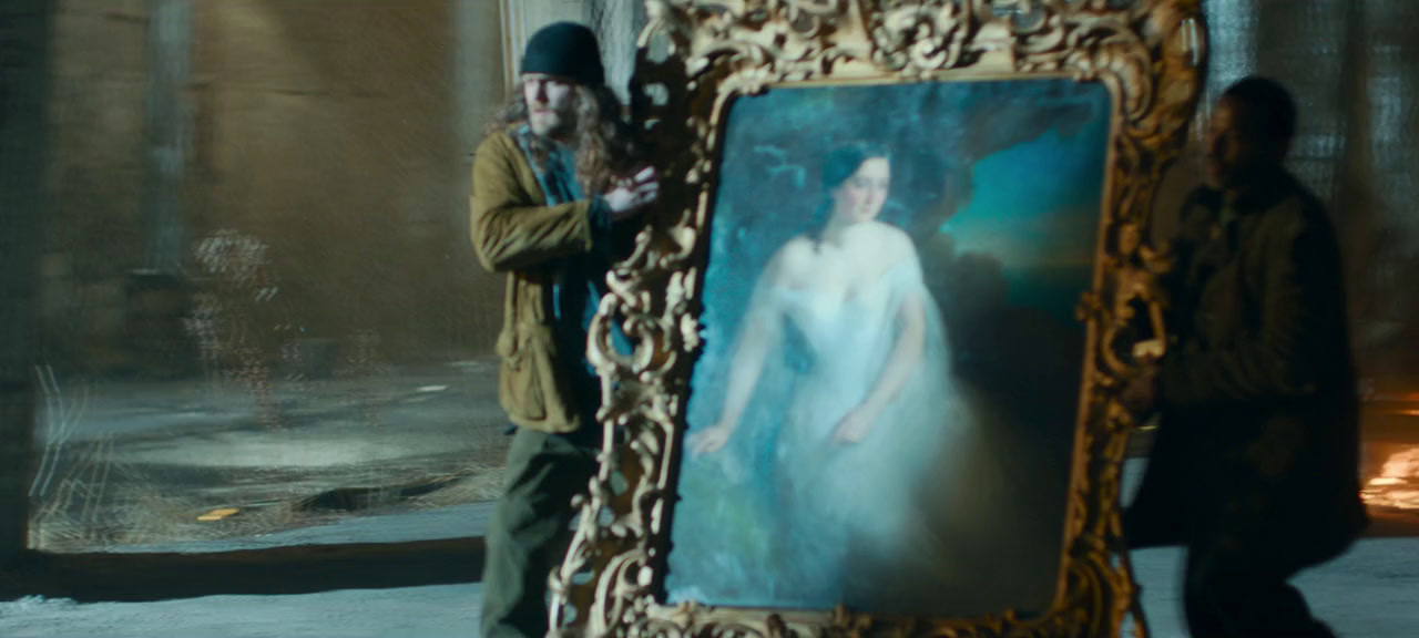 a man standing next to a picture of a woman