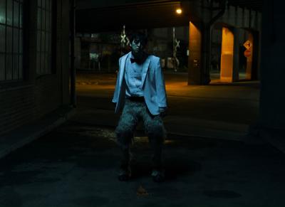 a man standing in the middle of a street at night