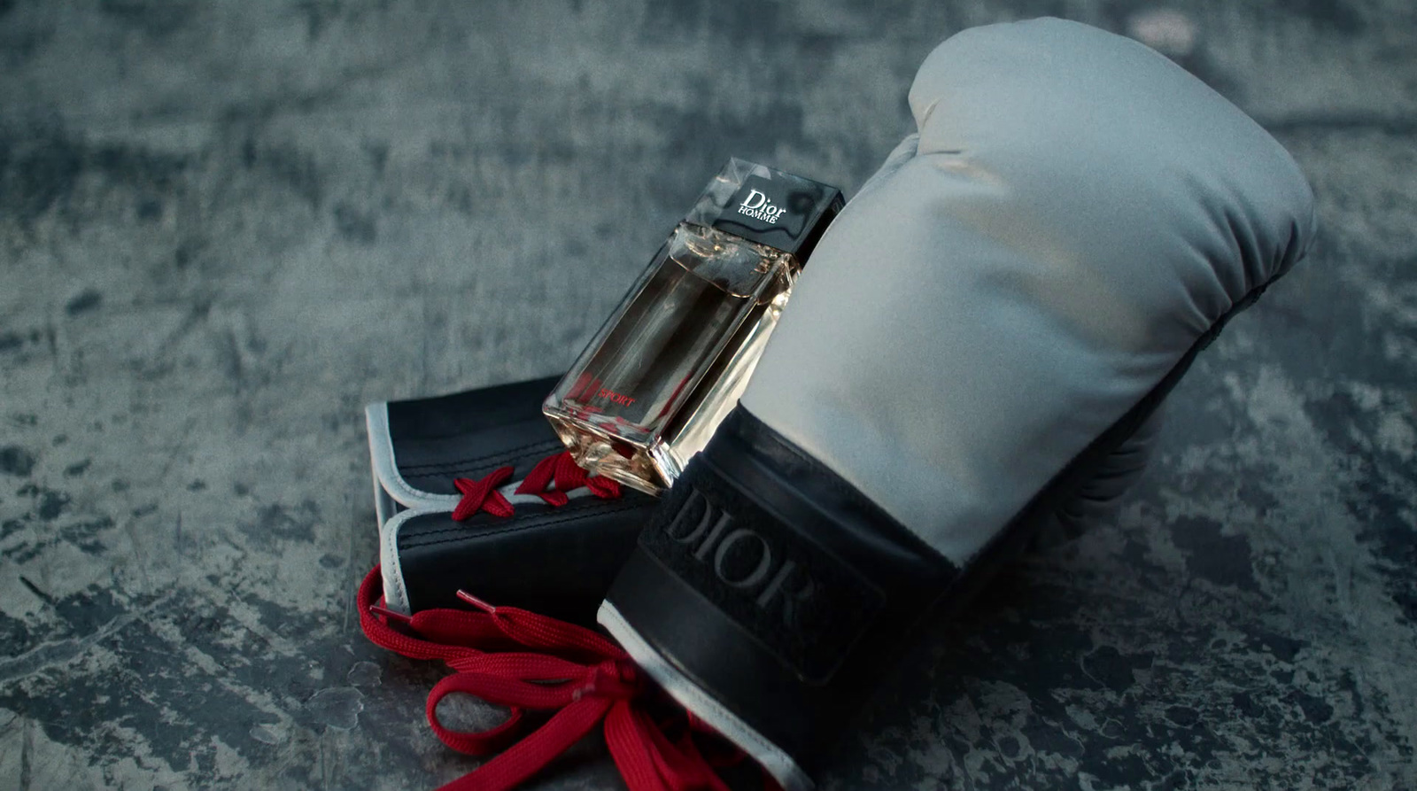 a pair of boxing gloves and a bottle of perfume