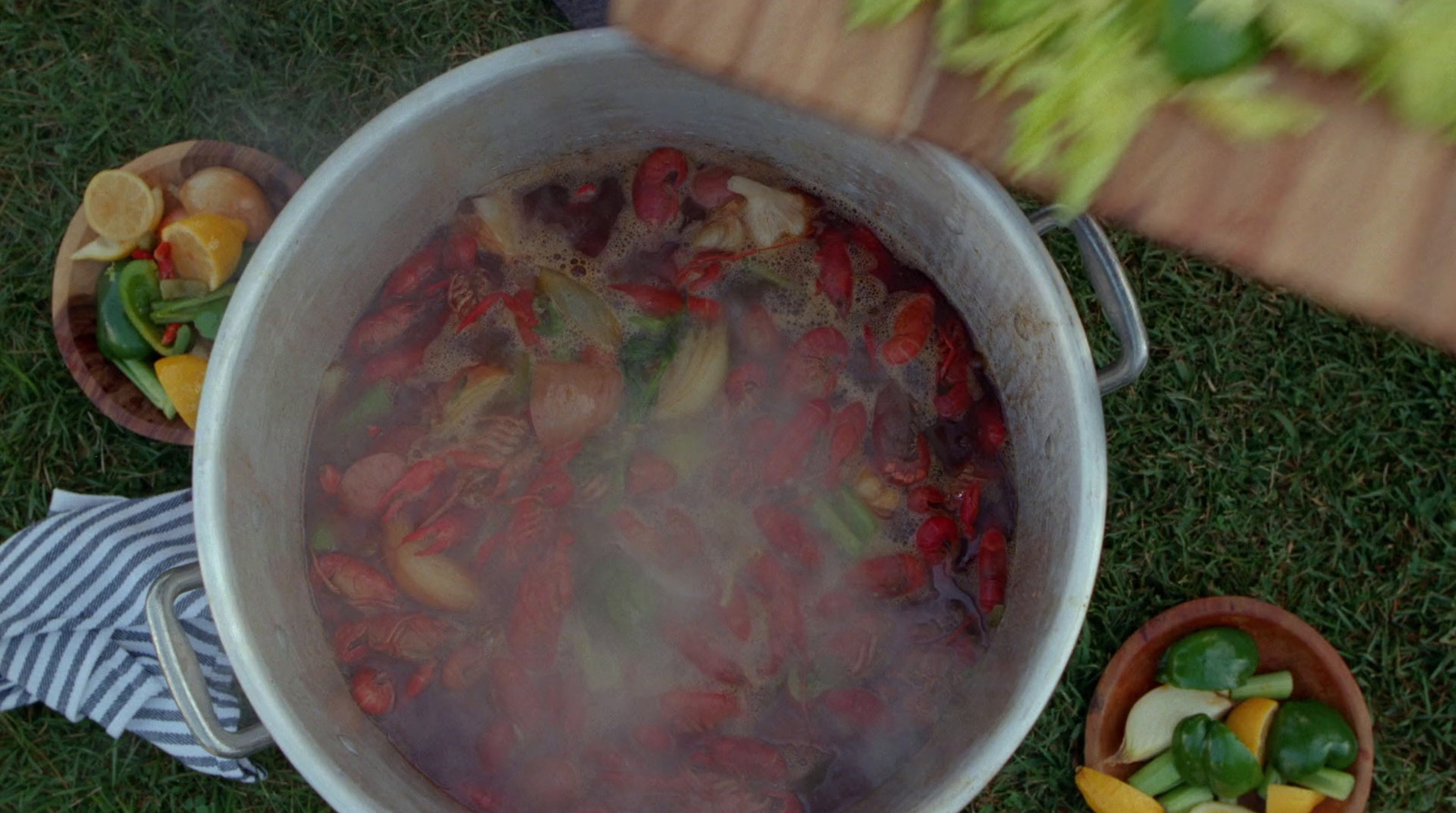 a large pot filled with lots of food on top of a green field