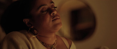 a woman laying down with her eyes closed