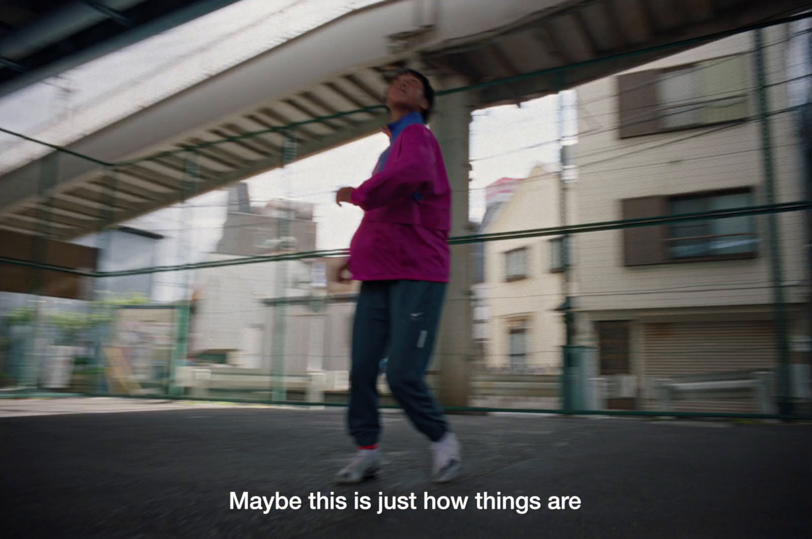 a woman in a pink jacket is skateboarding