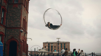 a man flying through the air while riding a hoop