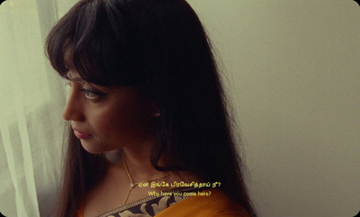 a woman with long hair looking out a window