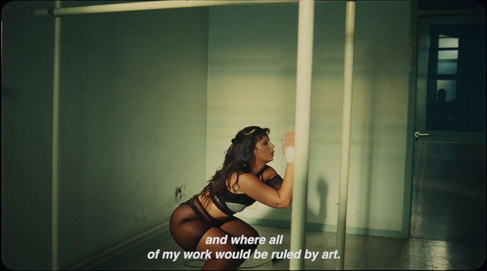 a woman in a black lingerie standing in a room