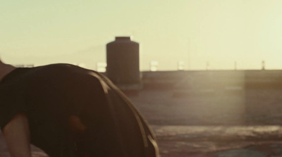 a man in a black shirt is holding a skateboard