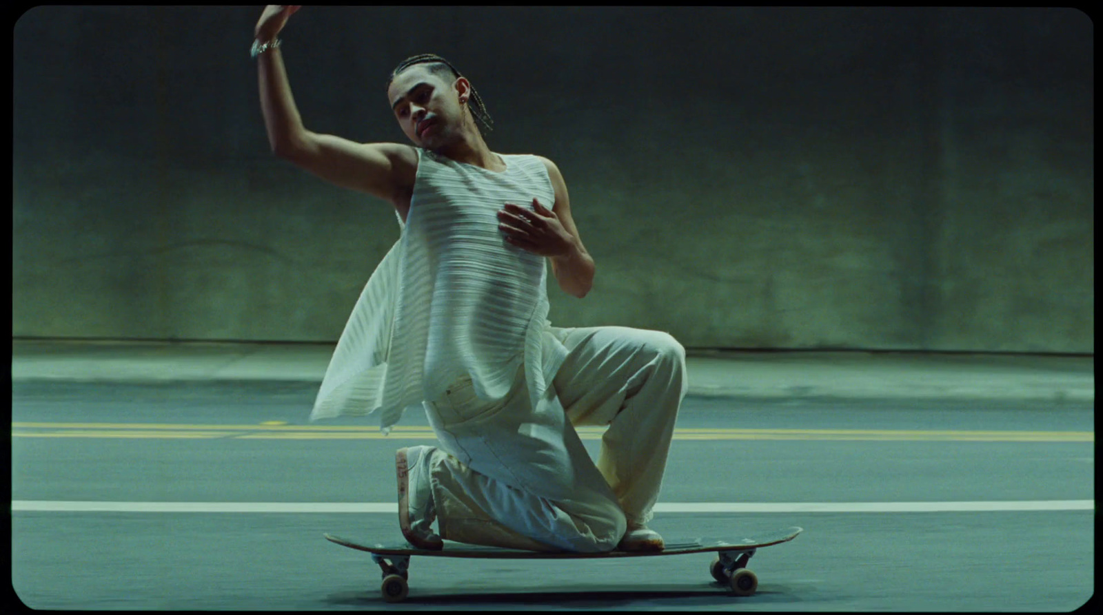 a man riding a skateboard down a street