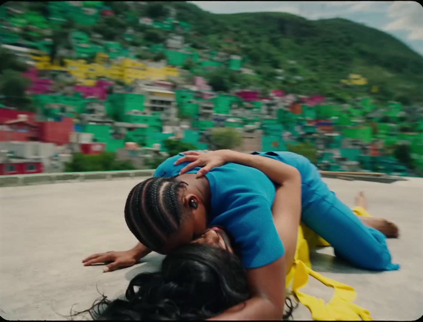 a woman laying on the ground next to another woman