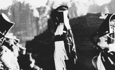 a black and white photo of two women dressed in medieval garb