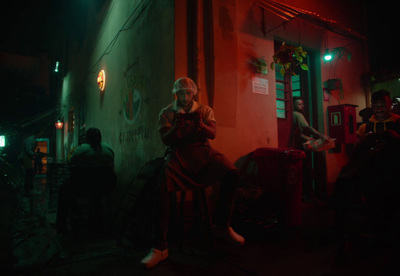 a man sitting on a chair next to a building