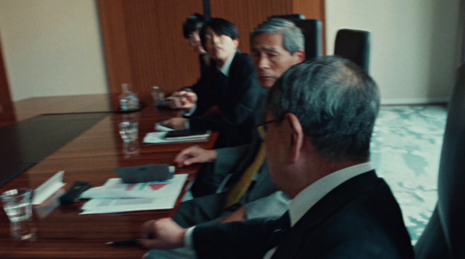 a group of people sitting around a wooden table