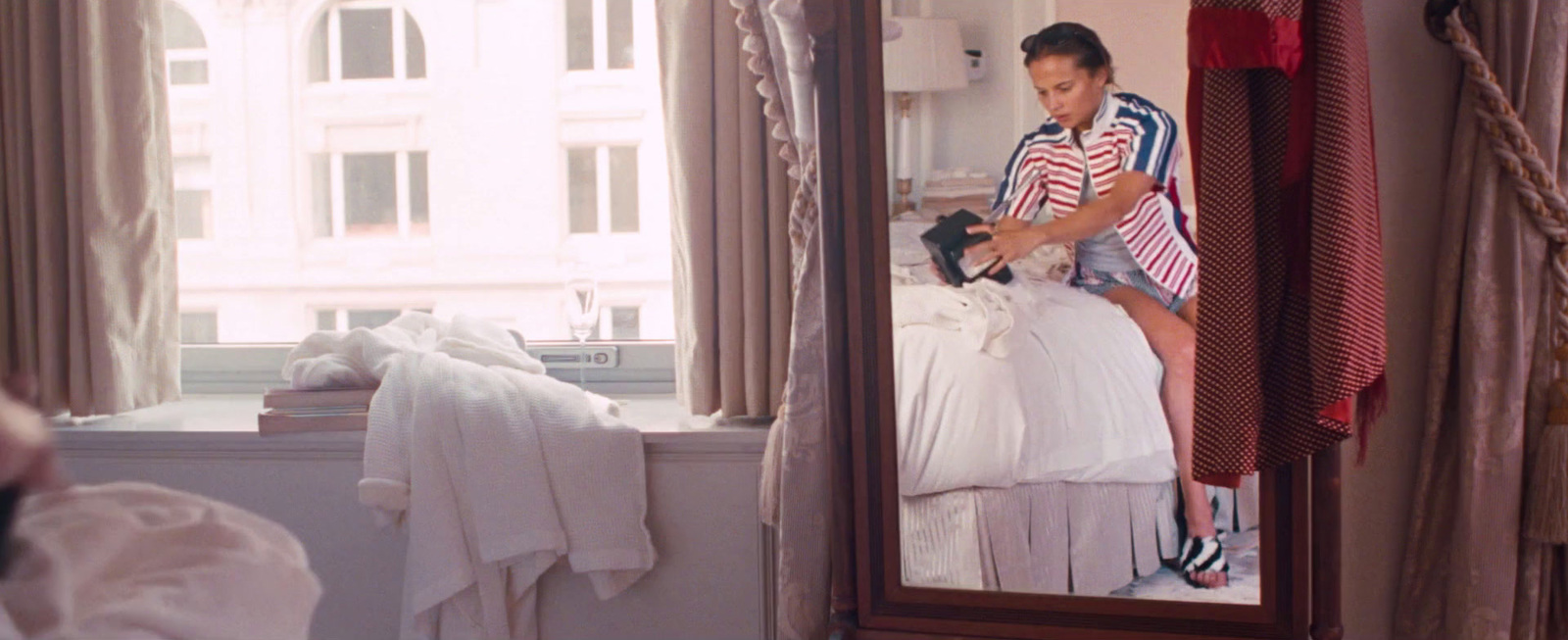 a woman taking a picture of herself in a mirror