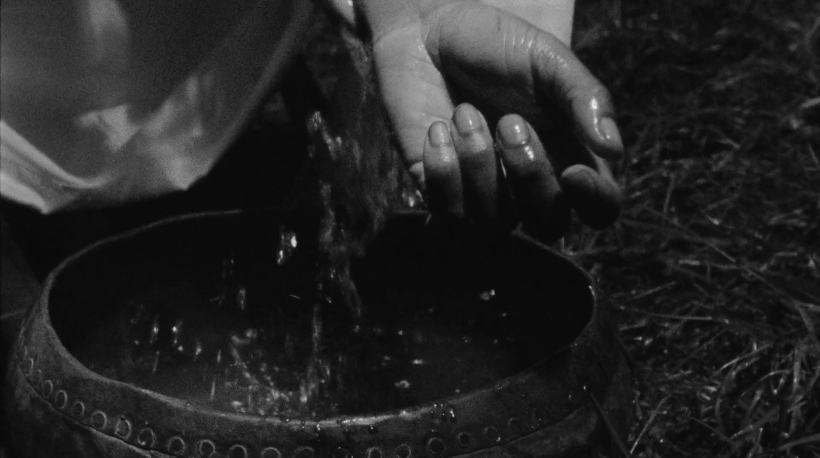 a person is pouring water into a bucket