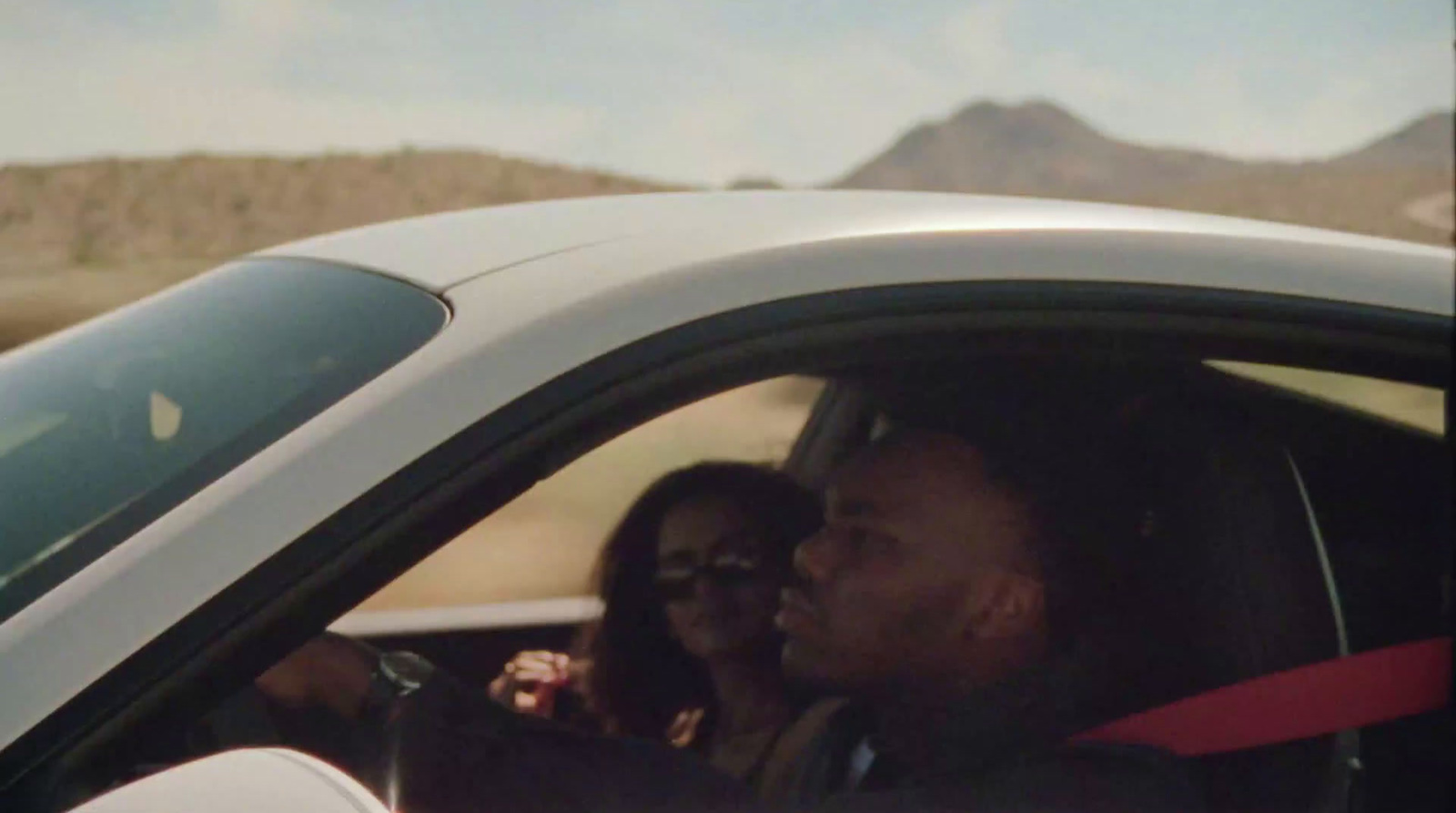 a man and a woman sitting in a car