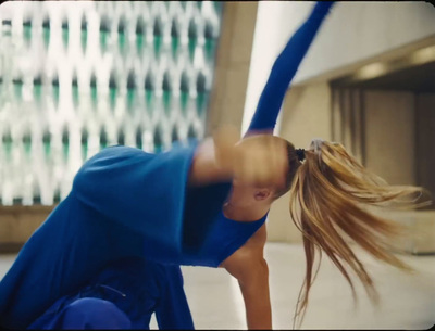 a woman in a blue dress is doing a handstand