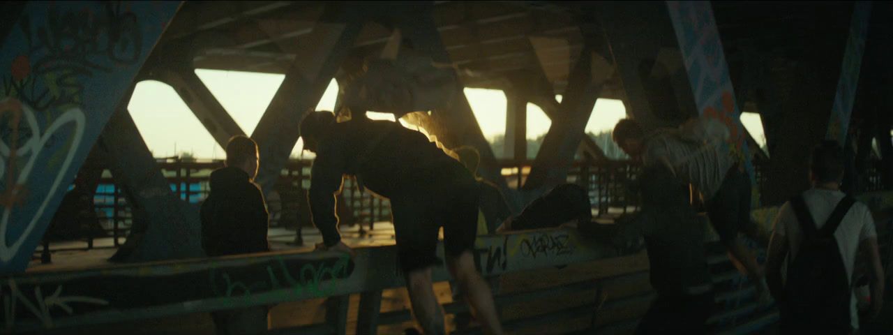 a group of people standing on top of a bridge