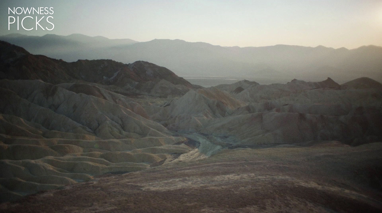 a view of a mountain range with a river running through it