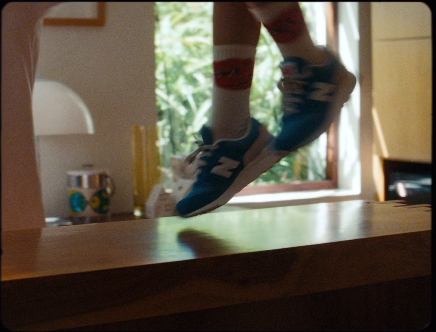 a person jumping in the air on a wooden table