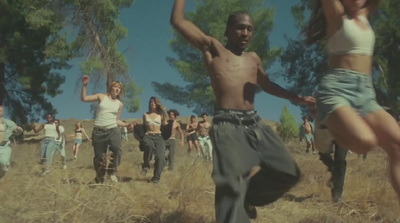 a group of people are dancing in a field