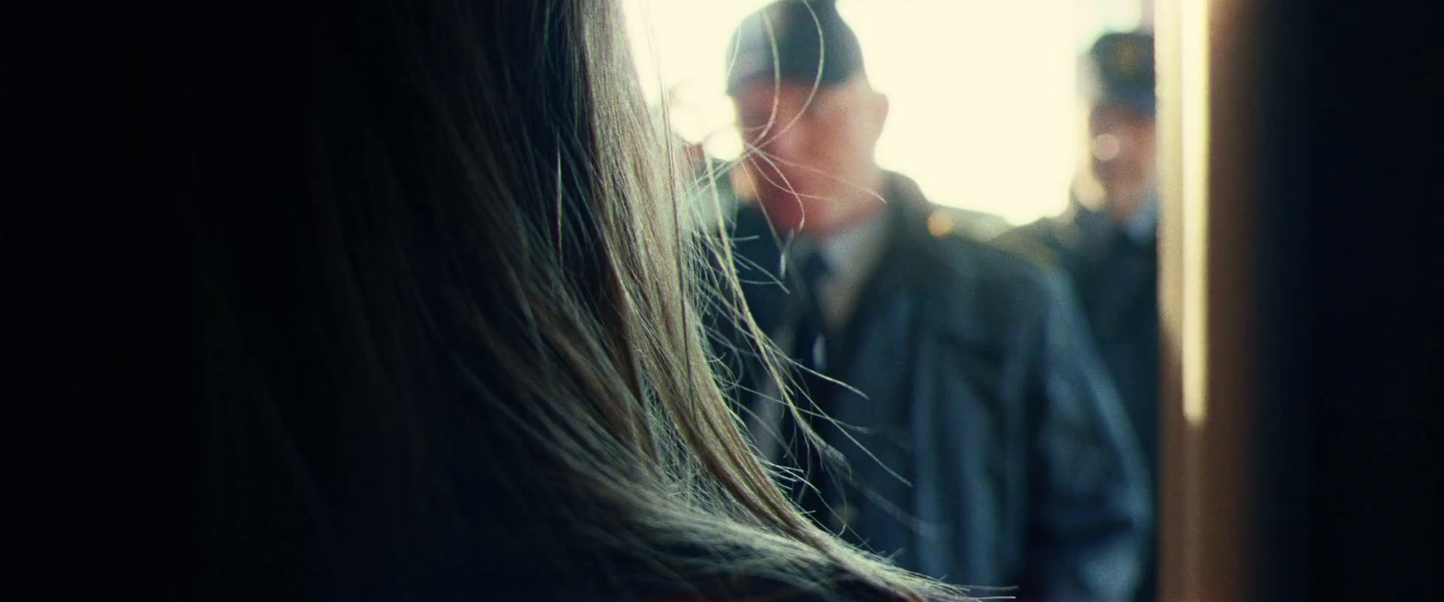 a woman with long hair standing in front of a man