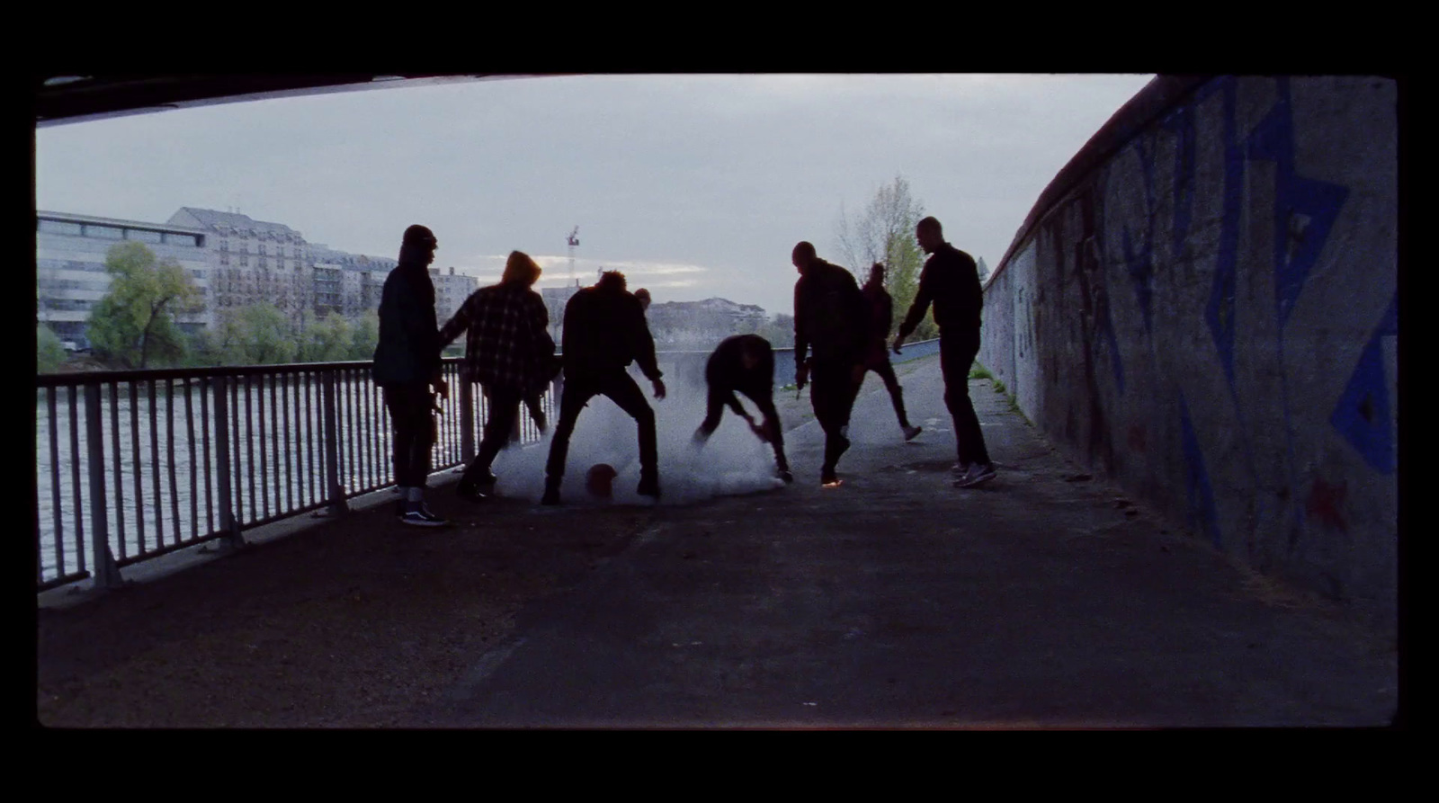 a group of people standing next to each other on a bridge