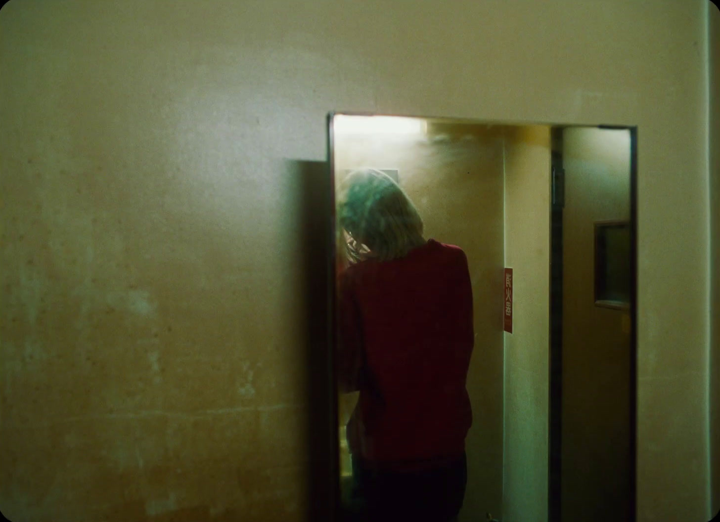 a woman standing in front of a mirror in a bathroom