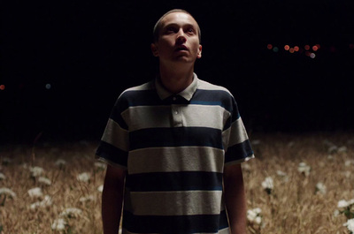 a man standing in a field of flowers