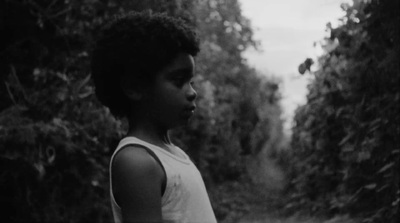 a black and white photo of a young boy