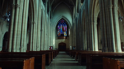 a church with pews and stained glass windows