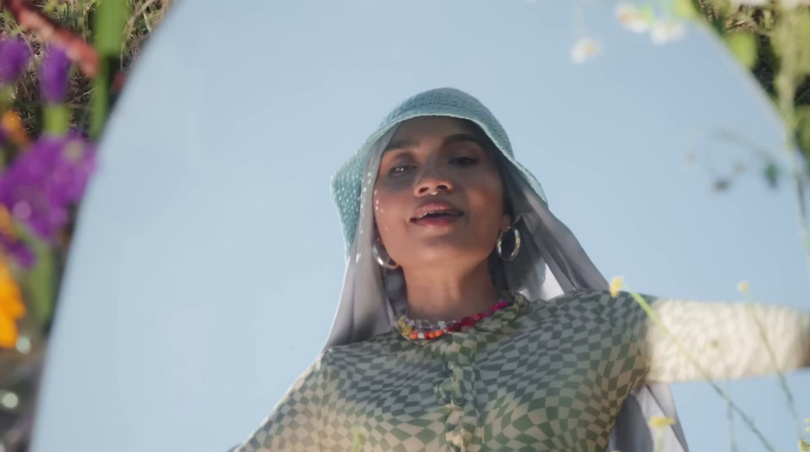 a woman with a veil on her head standing in front of a mirror