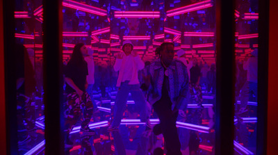 a group of people standing in a room with neon lights