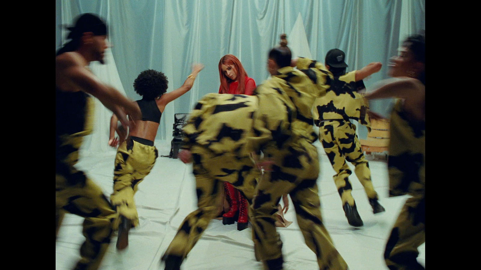 a group of people dressed in costumes dancing