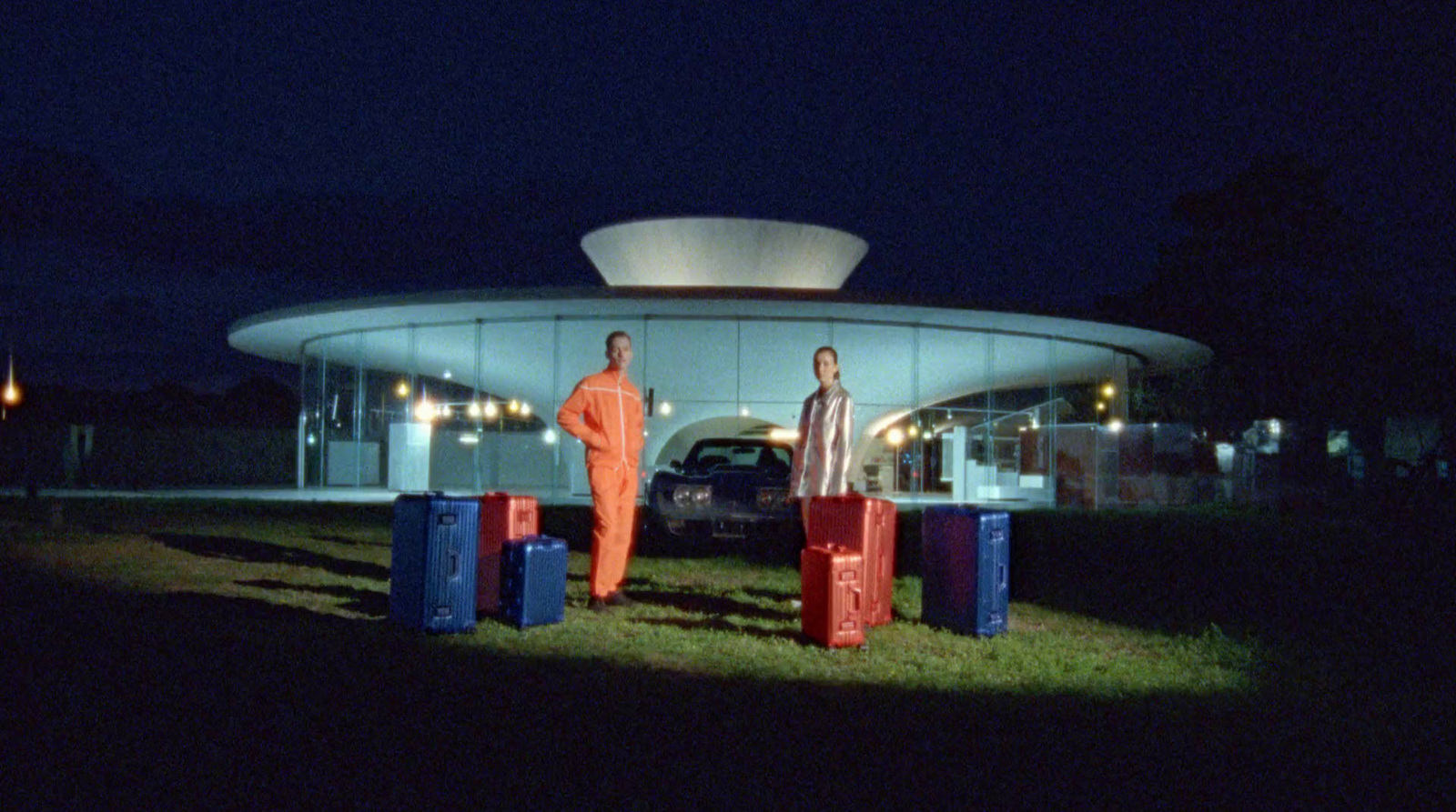 a couple of men standing next to each other in front of a building