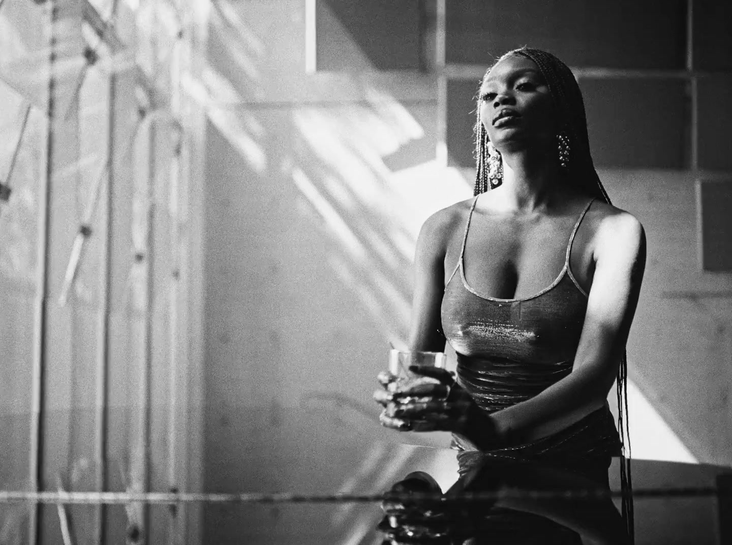 a black and white photo of a woman in a tank top