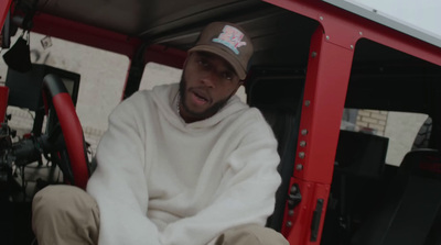 a man sitting in the driver's seat of a red truck